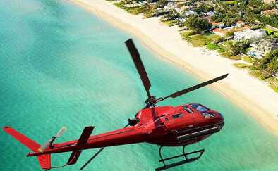 An helicopter flying over a beach