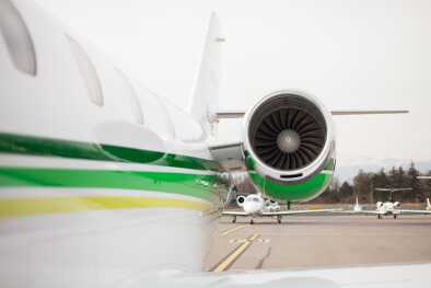 Zoom on a turbine of a private jet which is landed on a runway