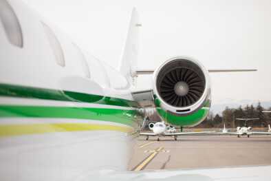 Zoom on a turbine of a private jet which is landed on a runway Zoom on a turbine of a private jet which is landed on a runway