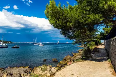 Vista del Sentier du Littoral en el Mar de Saint Tropez y varios yates en el agua Vista del Sentier du Littoral en el Mar de Saint Tropez y varios yates en el agua
